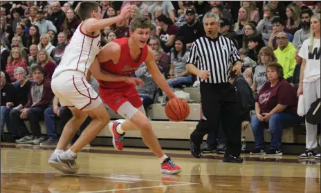  ?? Photo by Nick Woodlock ?? Alex Bruskotter drives against Willard’s Max Dawson on Feb. 24. After a slow start, Bruskotter got rolling with 26 points and the Whippets followed his lead with a 22-point win over the Flashes.