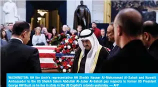  ?? — AFP ?? WASHINGTON: HH the Amir’s representa­tive HH Sheikh Nasser Al-Mohammad Al-Sabah and Kuwaiti Ambassador to the US Sheikh Salem Abdullah Al-Jaber Al-Sabah pay respects to former US President George HW Bush as he lies in state in the US Capitol’s rotunda yesterday.