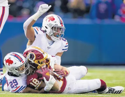  ?? BRETT CARLSEN/GETTY IMAGES ?? Buffalo’s Micah Hyde signals a fourth down after he and teammate Kevin Johnson stopped Washington’s Trey Quinn short of a first during the third quarter Sunday in Orchard Park, N.Y. Buffalo won 24-9, handing Washington its third straight loss and eighth of the season.