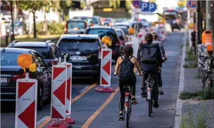  ??  ?? Cyclists use a ‘pop-up’ bike road in Kreuzberg district in Berlin, Germany. Photograph: Maja Hitij/Getty