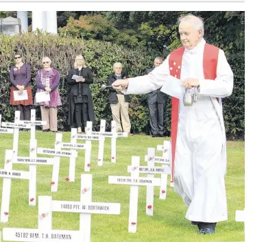  ?? PHOTO: HAMISH MACLEAN ?? Lest we forget . . . Father Dan Cummings performs the blessing at the Dedication of Crosses at the Lawrence Peace Garden in 2015.