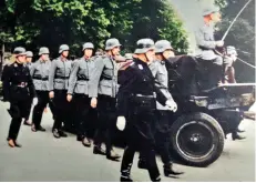  ?? ?? Dutch NSKK members provide the escort at the funeral of a Dutch collaborat­or killed by the Resistance. Note the wolf hook rune worn as a helmet decal