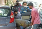  ?? PTI ?? Attendees load an oxygen cylinder for a Covid patient at a filling center in in New Delhi on Sunday. —