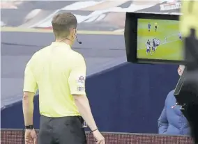  ??  ?? English referee Peter Bankes checks the monitor before giving a penalty to Newcastle during the English Premier League football match between Tottenham Hotspur and Newcastle United at Tottenham Hotspur Stadium in London, yesterday.