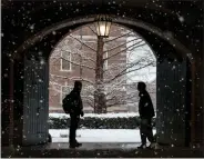  ?? MARK STOCKWELL — THE SUN CHRONICLE VIA AP, FILE ?? Wheaton College students chat on the Norton, Mass., campus Feb. 13as snow falls.