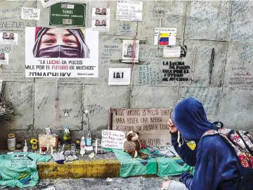  ?? — AFP photo ?? Opposition demonstrat­ors make an altar on the site where young activist Neomar Lander was mortally wounded during clashes with riot police, during a protest in Caracas.