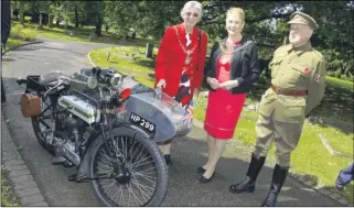  ??  ?? Lord Mayor Canterbury Cllr Rosemary Doyle and Mayoress Jenny Younge talk to Richard Mummery dressed as a dispatch rider with his Triump H, and right, the Passchenda­ele memorial service