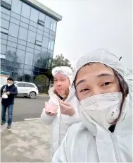  ??  ?? Wuhan resident Chen Hui poses for a selfie in a protective suit with another volunteer as they deliver meat and vegetables to constructi­on workers building a temporary hospital in Ezhou, Hubei province, China, Feb 11, following the outbreak of the novel coronaviru­s in the country. Chen Hui/Handout via Reuters