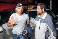  ?? AFP ?? Pakistan’s cricket captain Sarfraz Ahmed (left) gestures as he arrives at home in Karachi on Tuesday. —