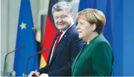  ?? (Fabrizio Bensch/Reuters) ?? GERMAN CHANCELLOR Angela Merkel and Ukraine’s President Petro Poroshenko address a news conference in Berlin yesterday.