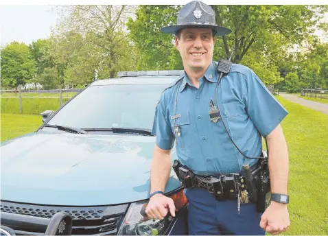  ?? STAFF PHOTO BY MATT WEST ?? HEROIC: Trooper Glenn Witaszek, above, who saved a woman from a burning car on the Mass Pike yesterday, said he doesn’t see himself as a hero and was just doing his job.