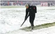  ?? THE ASSOCIATED PRESS ?? A worker clears snow from field lines at Soldier Field during Sunday’s NFL football game between the Chicago Bears and Cleveland Browns in Chicago.