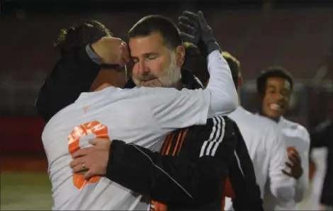  ?? AUSTIN HERTZOG - DIGITAL FIRST MEDIA ?? Perkiomen Valley head coach Bob McCabe hugs his son, senior Matt McCabe, after winning the PAC championsh­ip.