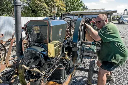  ?? PHOTO: DOUG FIELD/STUFF ?? Logan Eastham cranks up a 1923 6hp Stover engine at the the Annual Crank Up day at the Geraldine Vintage Car & Machinery Museum.