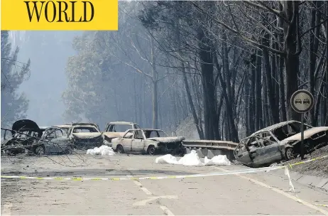  ?? ARMANDO FRANCA / THE ASSOCIATED PRESS ?? Burned-out cars line the road between Castanheir­a de Pera and Figueiro dos Vinhos, central Portugal, on Sunday after flames from a large-scale forest fire swept over the area, killing scores of people.