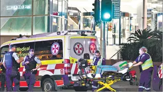 ?? ?? Paramedics move a stretcher with medical equipment outside the Westfield Bondi Junction shopping mall after a stabbing incident in Sydney on Saturday.