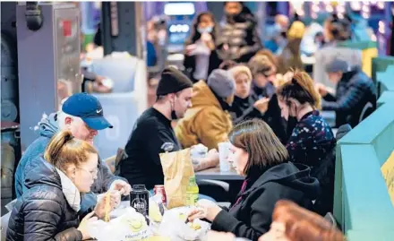  ?? MATT ROURKE/AP ?? Philadelph­ia lifted its vaccine restrictio­ns on indoor dining. Above, diners at the Reading Terminal Market.
