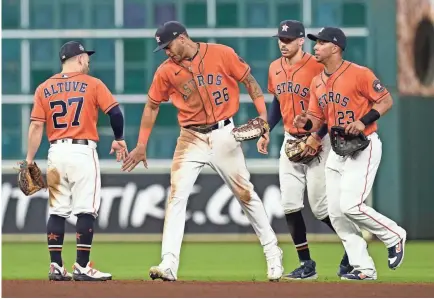  ?? THOMAS SHEA/USA TODAY SPORTS ?? Astros second baseman Jose Altuve (27) and center fielder Jose Siri (26) celebrate defeating the Braves in Game 2 of the World Series at Minute Maid Park on Wednesday. Altuve, who was in a 3-for-29 skid since the start of the ALCS entering the game, hit his 22nd home run of the postseason.