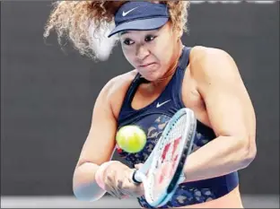  ?? DAVID GRAY/AFP ?? Japan’s Naomi Osaka hits a return against Spain’s Garbine Muguruza during their women’s singles match on Day 7of the Australian Open tennis tournament in Melbourne on Sunday.