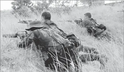  ??  ?? abFbNafNd lro iANa: poldiers are seen in iahad aatu – a valuable piece of real estate under siege. — Bernama photo