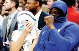  ??  ?? AIN’T THAT A SHAME: Golden State Warriors guard Stephen Curry, left, and forward Draymond Green, right, cover their faces as while sitting on the bench at the end of the team’s NBA game against the Utah Jazz on Tuesday in Salt Lake City. The Jazz won...
