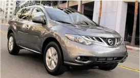  ??  ?? Murano’s shape is a curvy wedge with relatively long front and rear overhangs, with aerodynami­c, steep rakes that punctuate the front windshield and rear hatch. Eighteen-inch wheels and tires sit underneath big wheel wells that make the vehicle look...