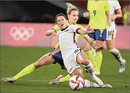  ?? Photograph­s by Wally Skalij Los Angeles Times ?? THE UNITED STATES’
Carli Lloyd is pulled down by Sweden’s Nathalie Bjorn for a foul in the second half of their Olympic opener.