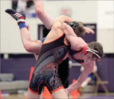  ??  ?? LaFayette’s Drake Bing lifts Heritage’s Ian Burgett during a 120-pound match at the Area 6-AAAA tournament at Gilmer on Saturday. (Messenger photo/Scott Herpst)