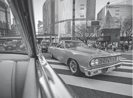  ?? PHILIP FONG/ AFP VIA GETTY IMAGES ?? This picture taken in January shows a 1964 Chevrolet El Camino Chevrolet seen through the window of a 1959 Cadillac Coupe DeVille during a gathering of auto enthusiast­s in Tokyo.