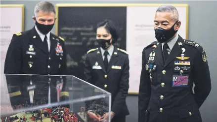  ?? AFP ?? US army Chief of Staff General James McConville, left, and Thailand’s army chief Apirat Kongsompon­g, right, looking at a display in the museum at the Thai Armed Forces headquarte­rs in Bangkok.