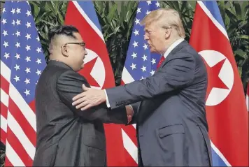  ?? Evan Vucci / Associated Press ?? In this June 12 photo, President Donald Trump shakes hands with North Korea leader Kim Jong Un at the Capella resort on Sentosa Island, in Singapore.