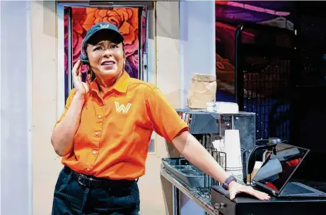  ?? Lynn Lane ?? Briana J. Resa stars as sassy Wanna-Burger worker Margot in the Alley Theatre production of “What-A-Christmas!”