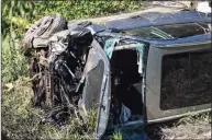  ?? Ringo H.W. Chiu / Associated Press ?? A vehicle rests on its side after a rollover accident involving golfer Tiger Woods in the Rancho Palos Verdes section of Los Angeles on Tuesday. Woods suffered leg injuries in the accident and was undergoing surgery, authoritie­s and his manager said.