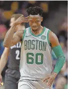  ?? STAFF PHOTO BY STUART CAHILL ?? MAKING HIS MARK: Jonathan Gibson gestures after a successful basket in the Celtics’ victory against the Nets last night.