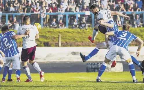  ??  ?? 0 Craig Halkett rises above the Cowdenbeat­h defence to put the Tynecastle side ahead after eight minutes at Central Park.