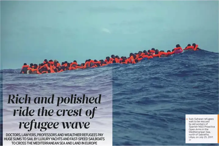  ?? AP ?? Sub-Saharan refugees wait to be rescued by aid workers of Spanish NGO Proactiva Open Arms in the Mediterran­ean Sea, north of Sabratha, Libya, on July 25, 2017.