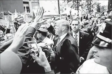  ?? SPENCER PLATT/GETTY ?? Republican presidenti­al nominee Donald Trump greets supporters outside Trump Tower in New York on Saturday.