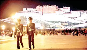  ??  ?? File photo shows two Chinese paramilita­ry policemen patrol near the iconic Potala Palace in the regional capital Lhasa, in China’s Tibet Autonomous Region. The US Congress has voted to demand access for US diplomats, journalist­s and tourists to Tibet, threatenin­g to bar the Chinese officials responsibl­e for the policy from the United States if the region remained walled off to foreigners. — AFP photo