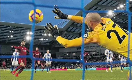  ?? PHOTO: ACTION IMAGES VIA REUTERS ?? Back of the net . . . Liverpool’s Mohamed Salah scores from the penalty spot against Brighton yesterday.