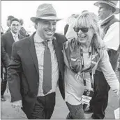  ?? HAYNE PALMOUR IV U-T ?? Trainer Peter Miller and publicist Joan Lawrence walk off the track after one of Miller’s horses won a race in the 2017 Breeders’ Cup at Del Mar.