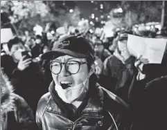  ?? ?? Silent no more: Protesters march along a Beijing street Monday.