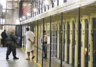  ?? Eric Risberg / Associated Press 2016 ?? A condemned inmate is led out of his cell on Death Row at San Quentin State Prison. An Arizona case that may come before the U.S. Supreme Court could alter California law.