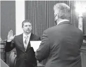  ?? PERRY BENNETT/WESTVIRGIN­IA LEGISLATUR­E ?? Lawmaker Derrick Evans, left, takes the oath of office last month.