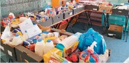  ??  ?? Volunteer Muhammad Johirul Islam (right) sorting out food packages.