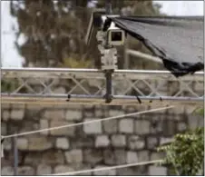  ?? MAHMOUD ILLEAN — THE ASSOCIATED PRESS ?? New security cameras are installed at the entrance to the Al Aqsa Mosque compound, in Jerusalem’s Old City, Sunday. Israel installed the cameras Sunday at the entrance to a sensitive Jerusalem holy site, as officials began indicating it was considerin­g...