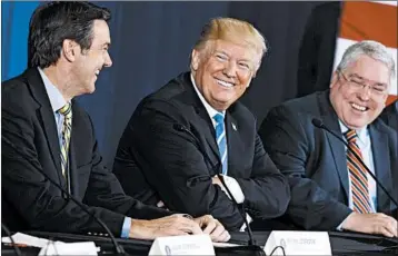  ?? EVAN VUCCI/AP ?? President Donald Trump discusses tax policy recently with U.S. Rep. Evan Jenkins, R-W.Va., left, and West Virginia Attorney General Patrick Morrisey at a W.Va. roundtable event. Republican­s say Trump needs do more to sell their tax cut deal.