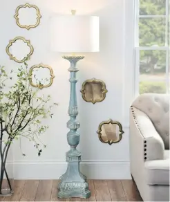  ?? HANDOUT ?? This vintage-style candlestic­k floor lamp makes a charming addition to a light-filled living room.