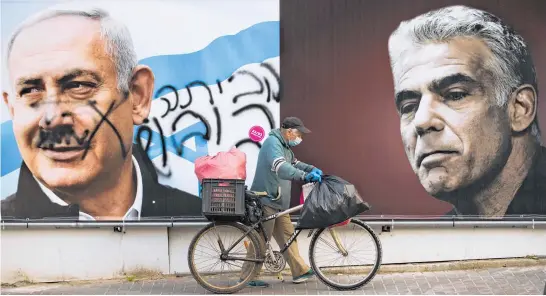  ?? Photo / AP ?? Graffiti on Benjamin Netanyahu’s (left) campaign billboard in Ramat Gan, Israel, reads “go home” in Hebrew.