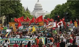  ?? Astrid Riecken / Getty Images ?? People march from the U.S. Capitol to the White House for the People’s Climate Movement on Saturday to protest President Donald Trump’s environmen­tal policies. Demonstrat­ors across the country are gathering to demand a clean energy economy.