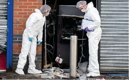  ??  ?? Devastatio­n: Forensics officers examine scene of the blast